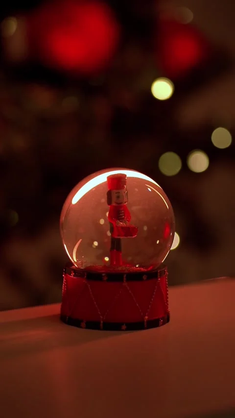 Vertical Snow Globe with Nutcracker Figurine in Warm Cozy Low Light Stock Footage 321354691