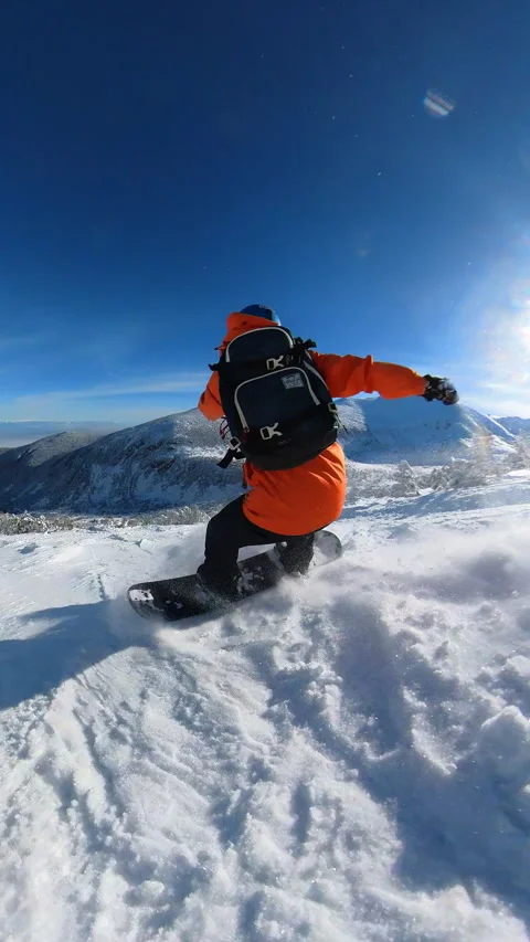 Vertical snowboarder navigating through a forest of snow-laden trees Video stock 262552927
