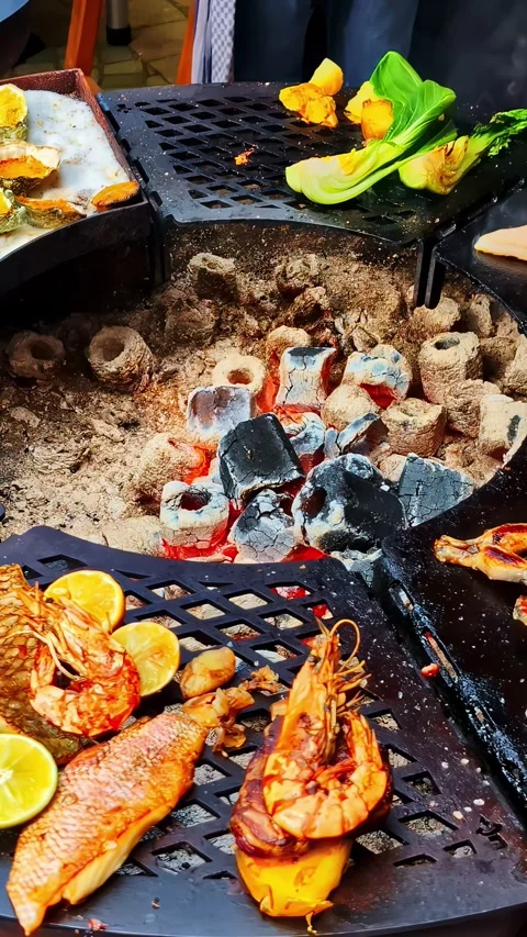 Vertical social ratio close-up video of a fire pit and various foods Stock Footage 336946175