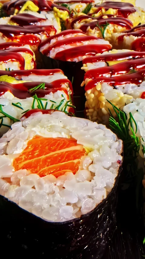 Vertical social ratio close-up video of sushi being prepped. A liquid glaze is Stock Footage 336946218