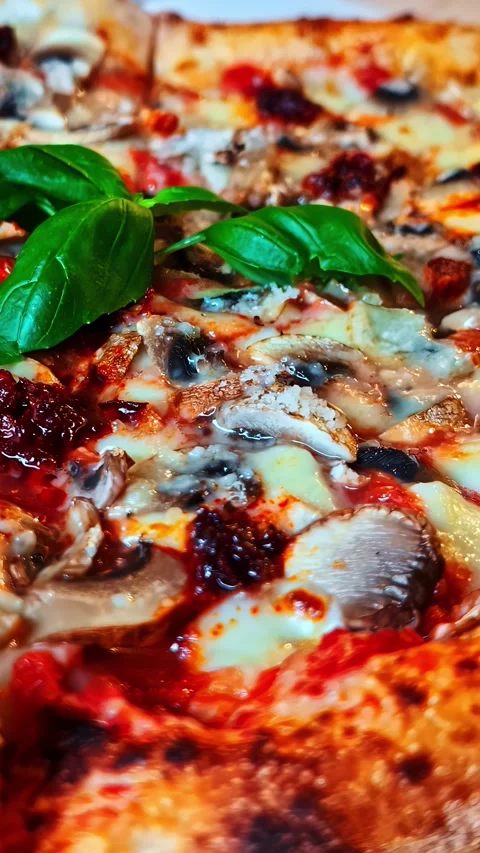 Vertical social ratio close-up video of a fish and mushroom based pizza Stock Footage 337136581
