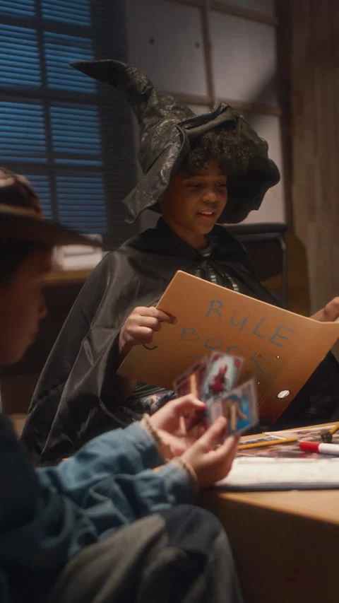 Vertical of Sorcerer Boy Managing Process of Table Game Stock Footage 278006804