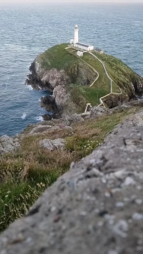 Vertical South stack lighthouse rugged welsh island coast slow motion Видео 341250843