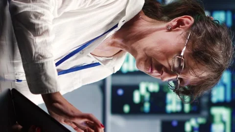 Vertical Specialist running code in server room Stock Footage 247797378