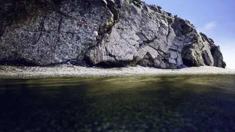 Vertical split exhibiting minimal plant life and tranquil waters Video stock 341819941