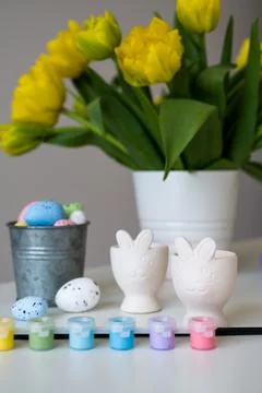 Vertical spring banner with paint,brush,pastel easter eggs,egg cups etc Stock Photos