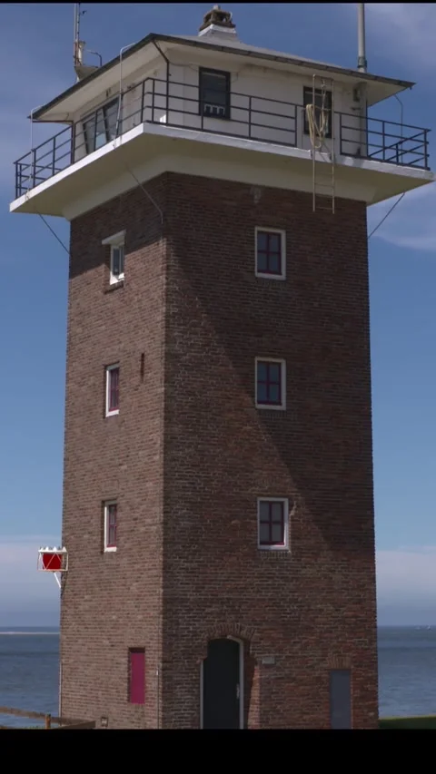 Vertical - square brick coastguard tower at North Sea coast Stock Footage 306955611