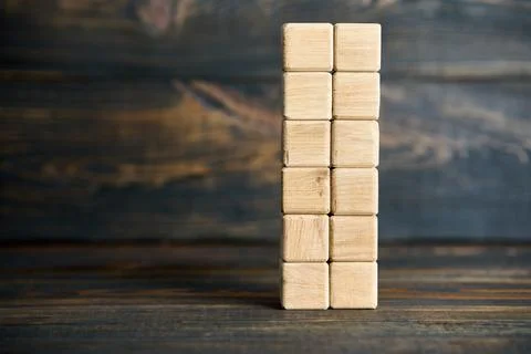 Vertical stack of blank wooden cubes on wooden surface 스톡 사진