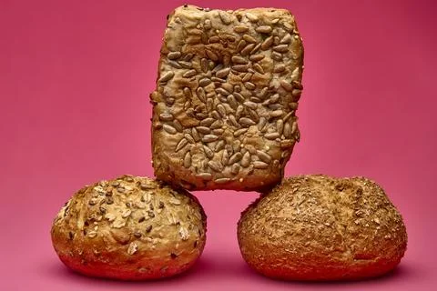 Vertical stack of bread pieces on pink background Stock Photos