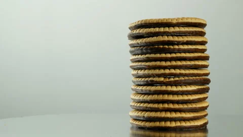 Vertical stack of chocolate cookies biscuits rotating slowly gray background 스톡 동영상 86399016