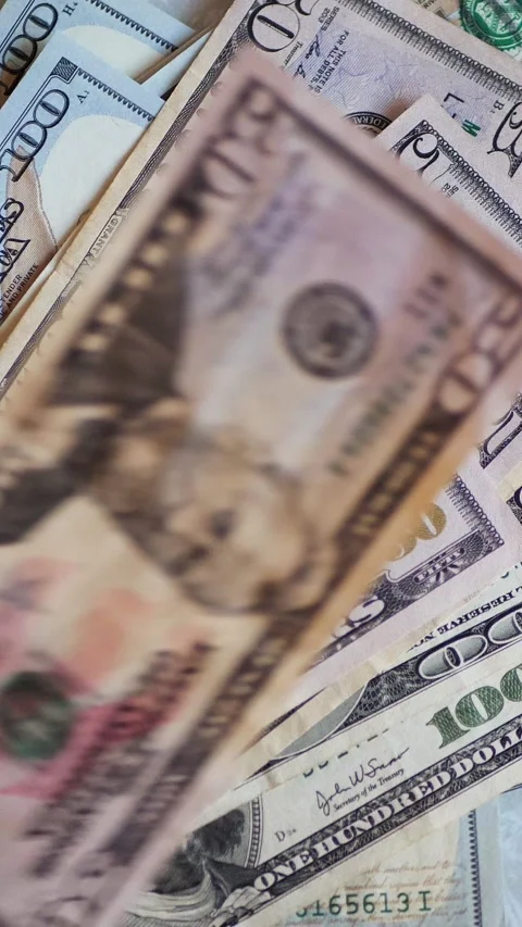 Vertical. A stack of crisp, dollar bills, held in capable hands. Stock Footage 304629458