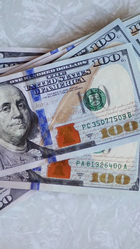 Vertical. A stack of crisp, dollar bills, held in capable hands. Stock Footage 304629491