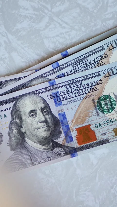 Vertical. A stack of crisp, dollar bills, held in capable hands. Stock Footage 304629505