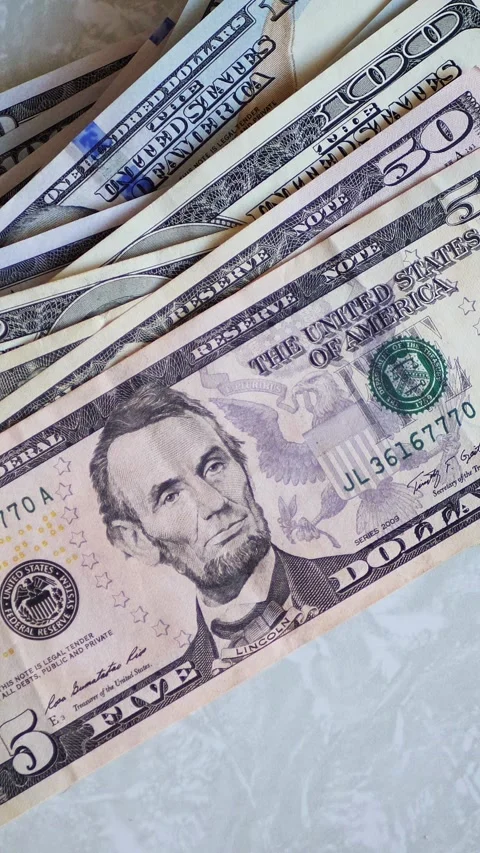 Vertical. A stack of crisp, dollar bills, held in capable hands. Stock Footage 304629545