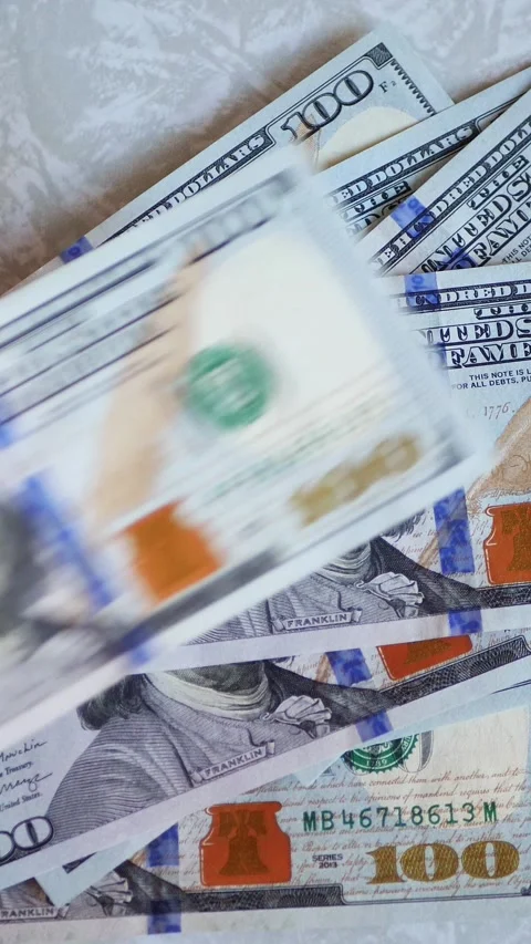 Vertical. A stack of crisp, dollar bills, held in capable hands. Stock Footage 304629548