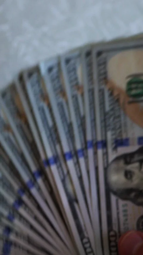 Vertical. A stack of crisp, dollar bills, held in capable hands. Stock Footage 304631865