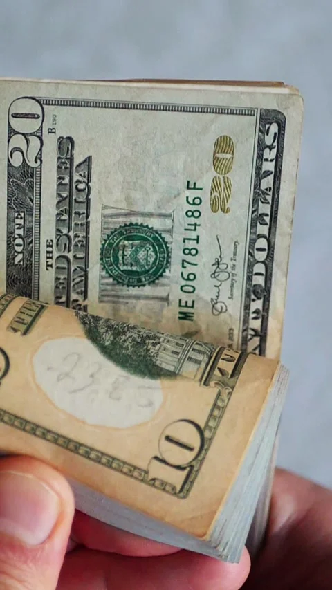 Vertical. A stack of crisp, dollar bills, held in capable hands. Stock Footage 304632637