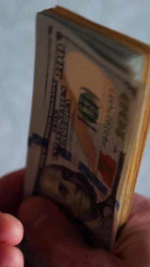 Vertical. A stack of crisp, dollar bills, held in capable hands. Stock Footage 304632664