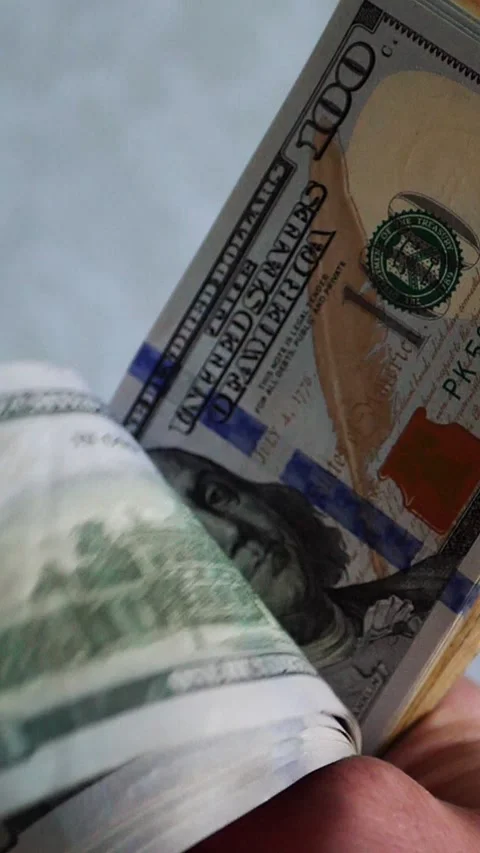 Vertical. A stack of crisp, dollar bills, held in capable hands. Stock Footage 304632665