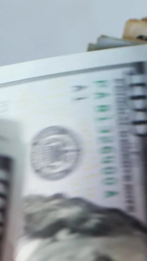 Vertical. A stack of crisp, dollar bills, held in capable hands. Stock Footage 304632907