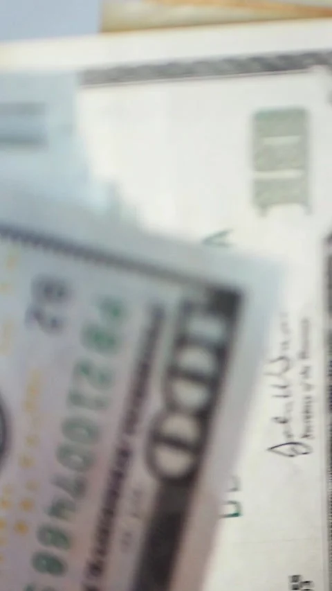 Vertical. A stack of crisp, dollar bills, held in capable hands. Stock Footage 304632909