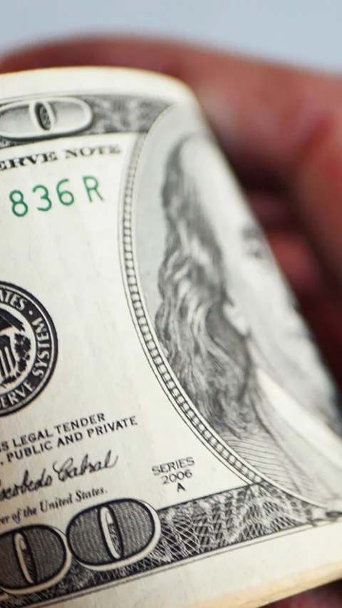 Vertical. A stack of crisp, dollar bills, held in capable hands. Stock Footage 304632917