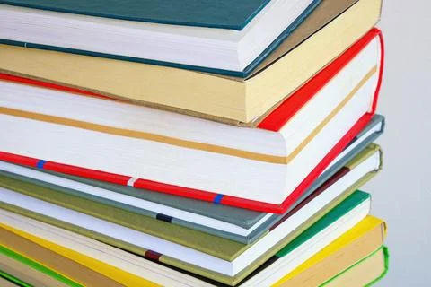 Vertical stack of different colorful books Stock Photos