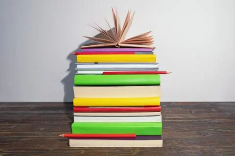 Vertical stack of different multi-colored books. Copy space Stock Photos