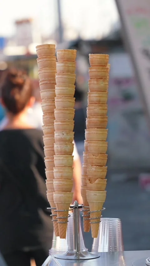 Vertical stack of empty waffle cones for Turkish ice cream Dondurma in the Video stock 303739450