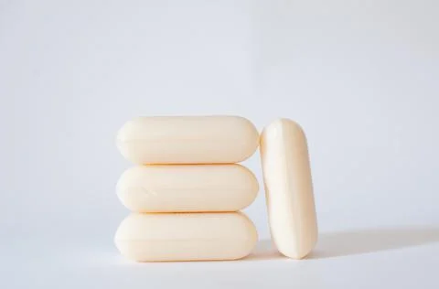 Vertical stack of natural soap bars with profile view isolated on white. Foto stock