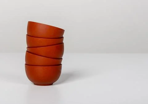 Vertical stack of small ceramic bowl cups arranged. handcrafted pottery, bann Stock Photos