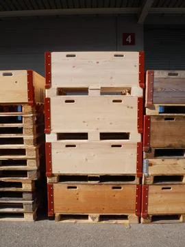 Vertical stack of wooden industrial boxes and shipping pallets at a warehou.. Stock Photos