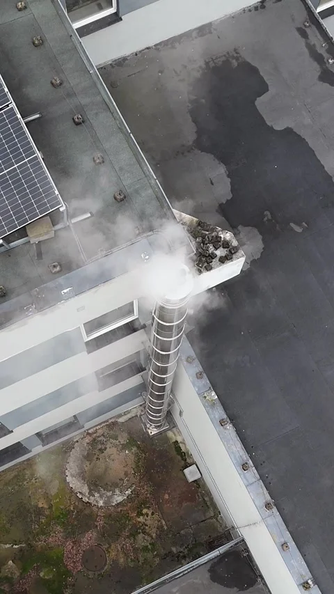 Vertical Static Aerial Hover Over Smoking Chimney and Solar Panels Stock Footage 323965616