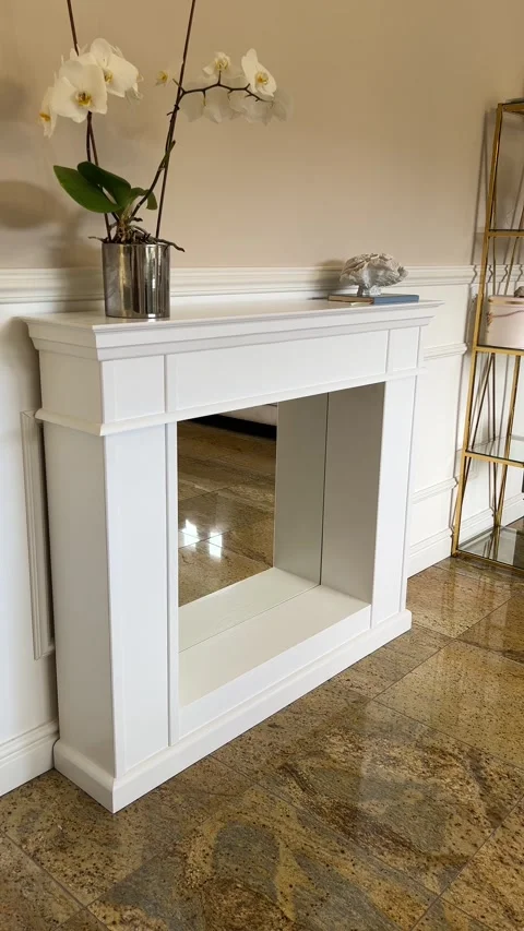 Vertical static angle view of elegant white handcrafted wooden fireplace mantle Видео 342953784