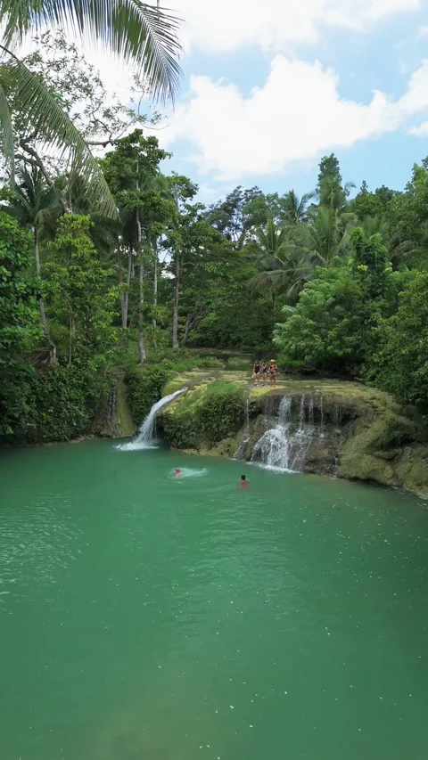 Vertical static shot of a person jumping into the natural pool at Niluksuan Stock Footage 345174260