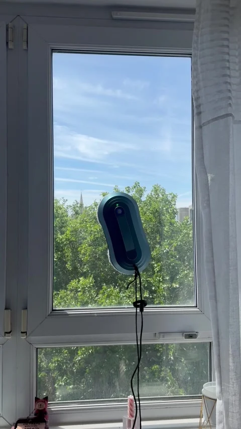Vertical static shot of window washer cleaning lower part of glass pane Stock Footage 336907259
