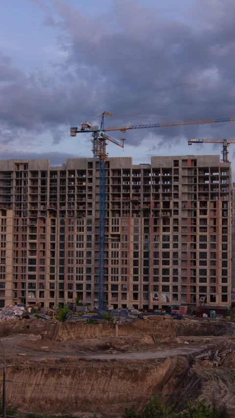 Vertical static time lapse shot of a massive concrete apartment building unde Stock Footage 335688277