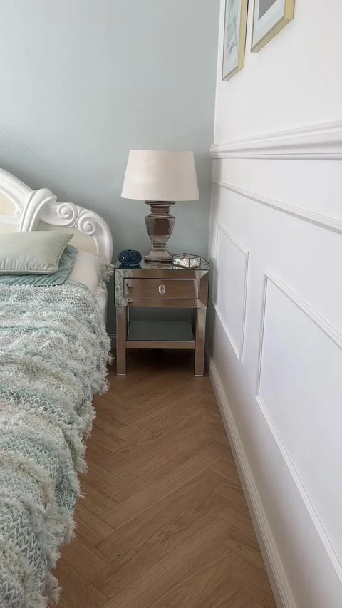 Vertical static view of luxury bedroom with mirrored nightstand and wall molding Stock-Footage 346488743