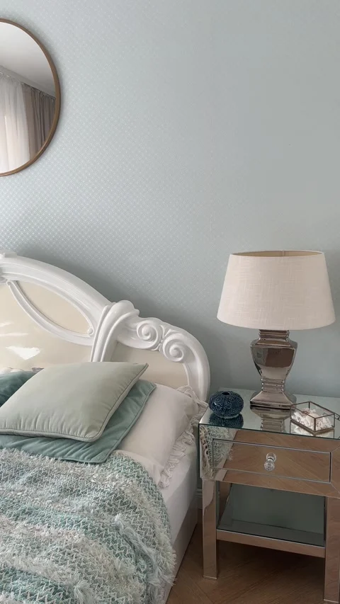 Vertical static view of luxury bedroom with round mirror and mint wallpaper Stock Footage 346488751