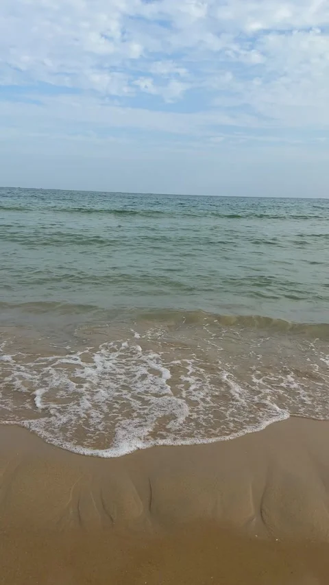 Vertical Static View of Waves Crashing on Sandy Beach 4K Stock Footage 331897413