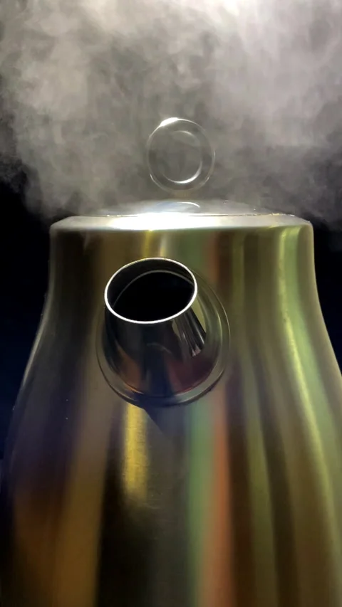 Vertical - Steam rising from the spout of a boiling, steel electric kettle. Stock Footage 288340837