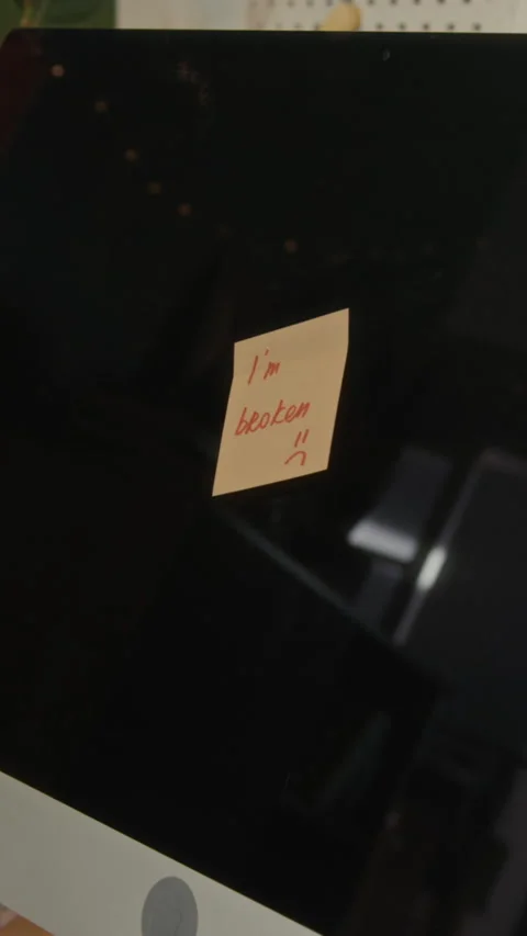 Vertical of Sticky Note on Broken Computer Screen Showing Financial Stress Stock Footage 336637459