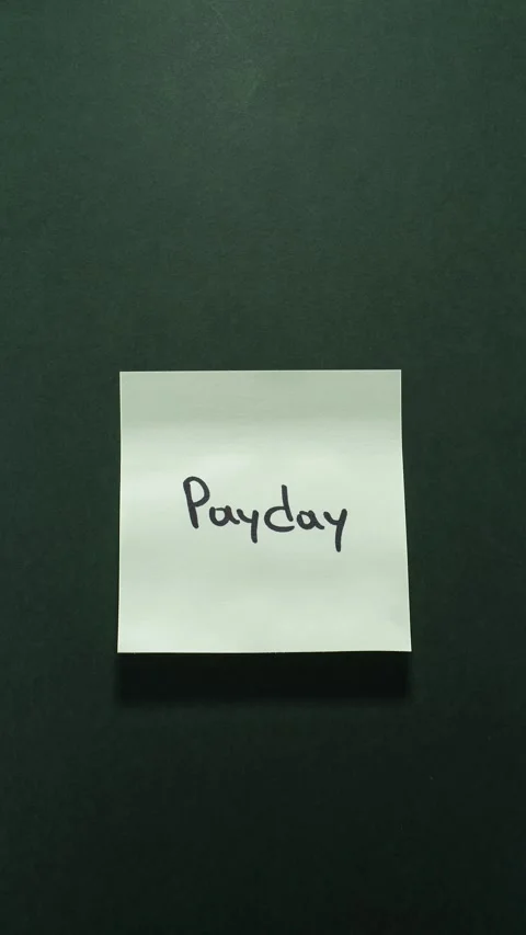 Vertical Sticky Note with "Payday" Message on Dark Green Background Stock Footage 316199701