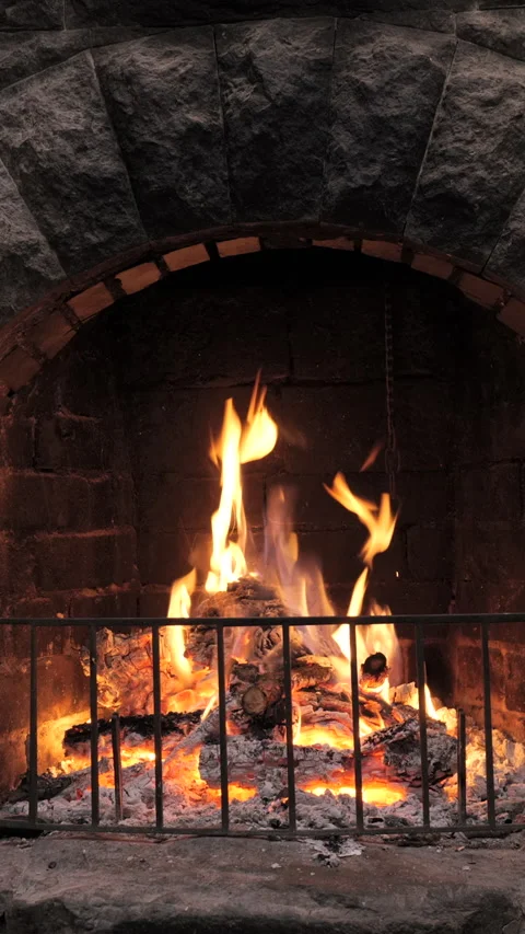 Vertical stone fireplace with burning fire Stock Footage 313471541