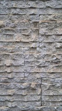 Vertical stone wall texture with rectangular blocks Stock Photos