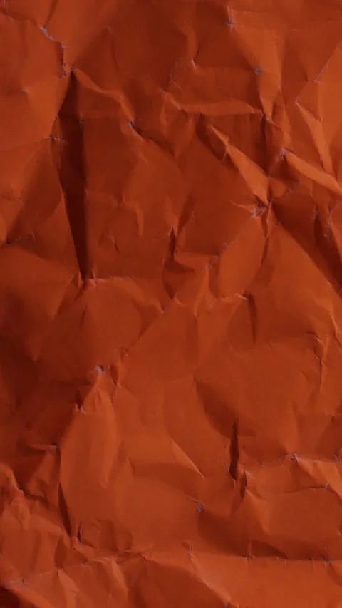 Vertical stop-motion animation of neon orange wrinkled paper. Seamless loop f Stock Footage 335894913