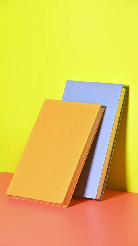 Vertical Stop Motion of Books Pushing Against the Pastel background Stock Footage 258599071