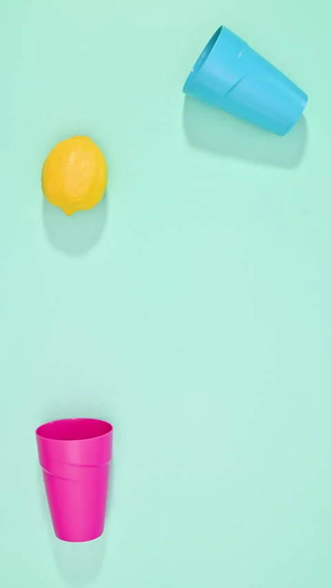 Vertical stop motion of pouring fresh lemon from one glass to another. Stock Footage 280132624