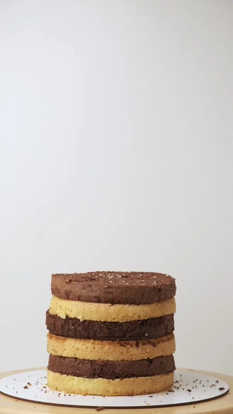 Vertical stop motion video of biscuit sponge cake assembling Stock Footage 250194889
