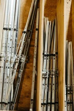 Vertical storage of metal hinges in carpentry workshop Foto stock